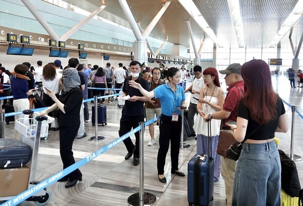 호치민공항 3터미널에서 승객들을 안내 중인 지상직 승무원의 모습. 비엣젯항공을 제외한 베트남 항공업계가 남부 호치민시 떤선녓공항에서 운항 중인 국내선 운항편을 모두 3터미널로 이전한다.(사진=tuoitre)