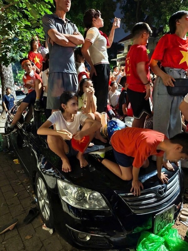 길가에 주차된 차량위에 올라타 열병식 예행연습을 관람 중인 베트남인들의 모습. 베트남 수도 하노이에서 80주년 독립기념일 열병식 리허설이 진행 중인 가운데 많은 사람들이 관람 후 쓰레기를 무단 투기하거나 당국의 통제를 따르지 않는 등 부족한 시민 의식의 민낯을 드러냈다. (사진=SNS)